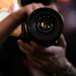 person-holding-black-camera-lens.jpg person holding black camera lens
